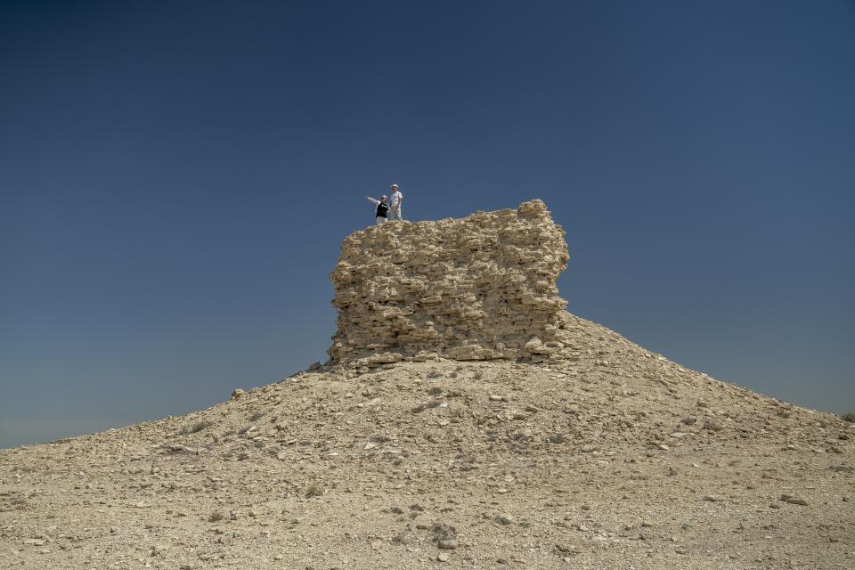 A couple visits a devastated village and areas near the dried-up Aral Sea, outside Muynak, Uzbekistan, Saturday, June 24, 2023. (AP Photo/Ebrahim Noroozi)