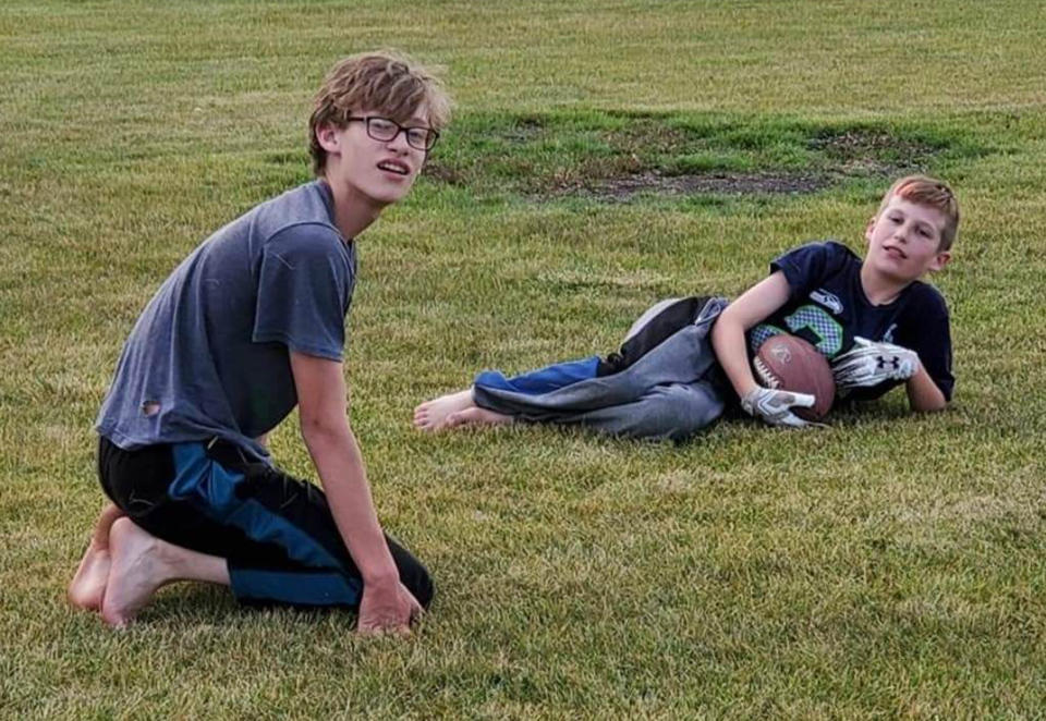 Eric Masker's two oldest sons, taking a break from football to pose for a picture on the field. (Courtesy Eric Masker)