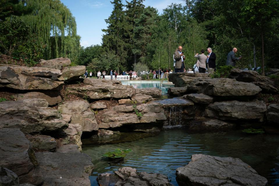 Guests gather for a pool and lagoon restoration celebration at the Ford House in Grosse Pointe Shores on Monday, August 1, 2022. The pool and lagoon is now open to visitors six days a week for a $5 admission fee, although swimming will not be allowed.