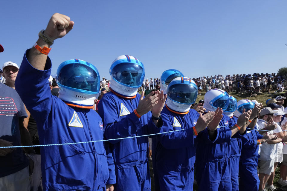 Golf fans in dressed a mock space suits line the 6th fairway as they watch during the afternoon Fourballs matches at the Ryder Cup golf tournament at the Marco Simone Golf Club in Guidonia Montecelio, Italy, Friday, Sept. 29, 2023. (AP Photo/Andrew Medichini)