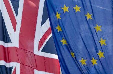 The Union Flag flies next to the European Flag outside the European Commission building in central London, in this May 25, 2014 file photograph. REUTERS/Neil Hall/files