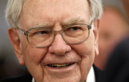 Berkshire Hathaway CEO Warren Buffett listens to a shareholder at the Berkshire-owned Borsheims jewelry store where Buffett was selling jewelry as part of the company annual meeting weekend in Omaha, Nebraska May 4, 2014. REUTERS/Rick Wilking