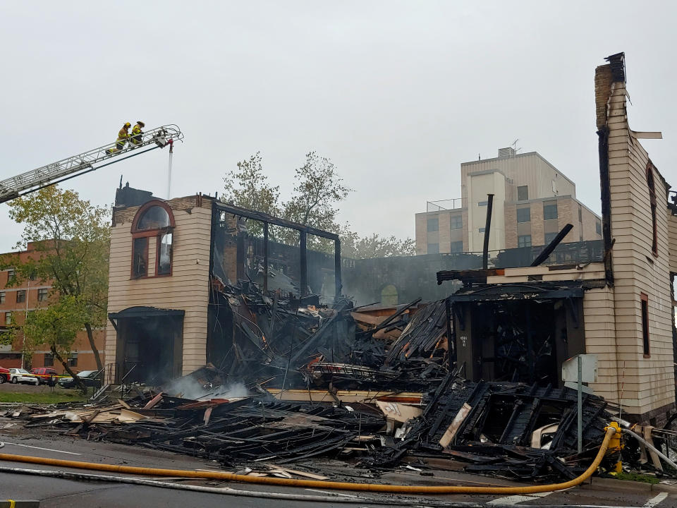 Firefighters work the scene of an overnight fire that engulfed and destroyed a synagogue in downtown Duluth, Minn., Monday, Sept. 9, 2019. (Brooks Johnson/Star Tribune via AP)