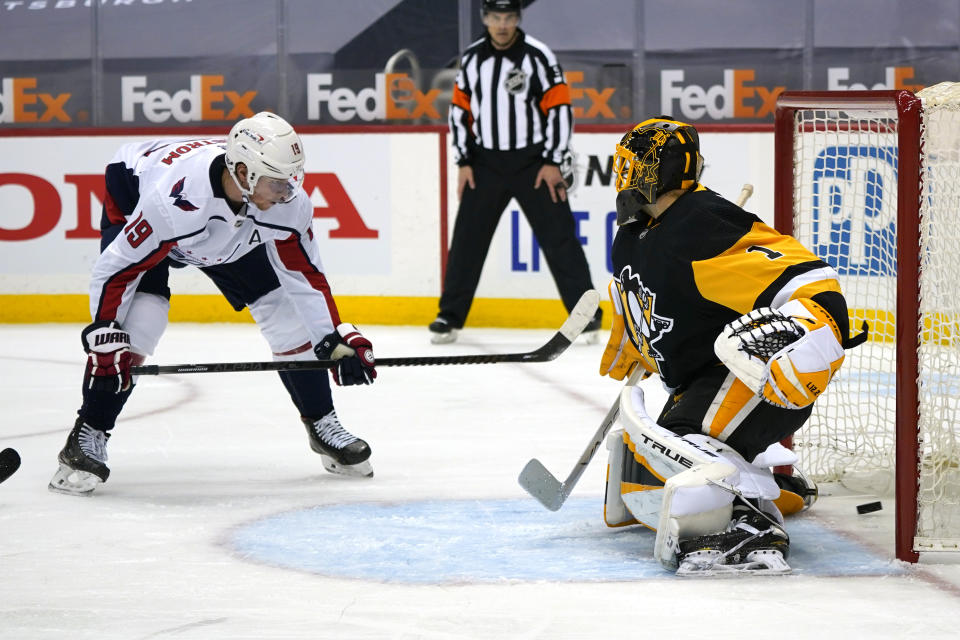Washington Capitals' Nicklas Backstrom (19) puts the puck behind Pittsburgh Penguins goaltender Casey DeSmith for a goal during the second period of an NHL hockey game in Pittsburgh, Sunday, Jan. 17, 2021. (AP Photo/Gene J. Puskar)
