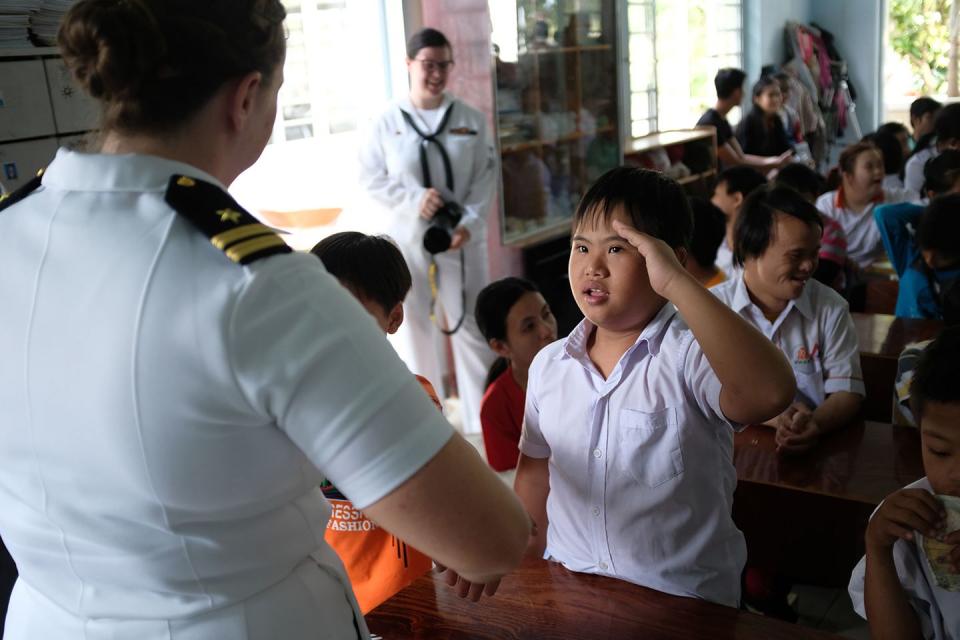 <p>A Vietnamese victim of Agent Orange salutes a US Navy sailor during a four-day port voyage to pay tribute to those affected by the 21-million-gallons of the chemical unleashed on the Vietnamese population during the Vietnam War. The attack has caused cancer, birth defects, and neurological diseases spanning generations.</p>