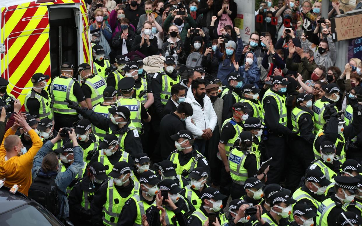 Two men are released from the back of an Immigration Enforcement van last week - Andrew Milligan/PA