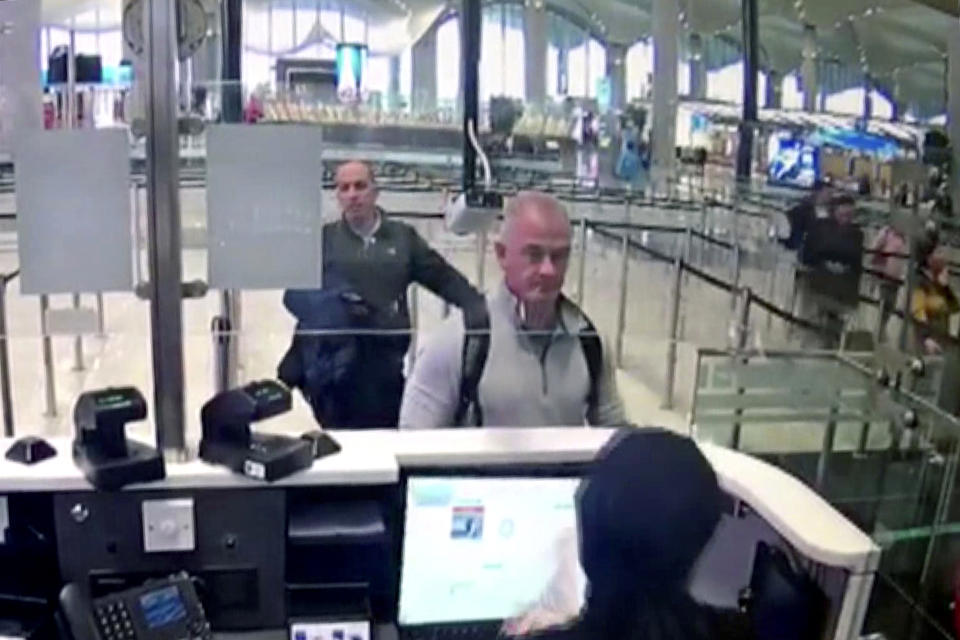 FILE - This Dec. 30, 2019, file image from security camera video shows Michael L. Taylor, center, and George-Antoine Zayek at passport control at Istanbul Airport in Turkey. Michael Taylor and his son Peter, suspected of helping former Nissan Chairman Carlos Ghosn skip bail and escape to Lebanon in December 2019 have been extradited to Japan. They were handed over to Japanese custody on Monday, March 1, 2021 and were due to arrive in Tokyo on Tuesday. (DHA via AP, File)