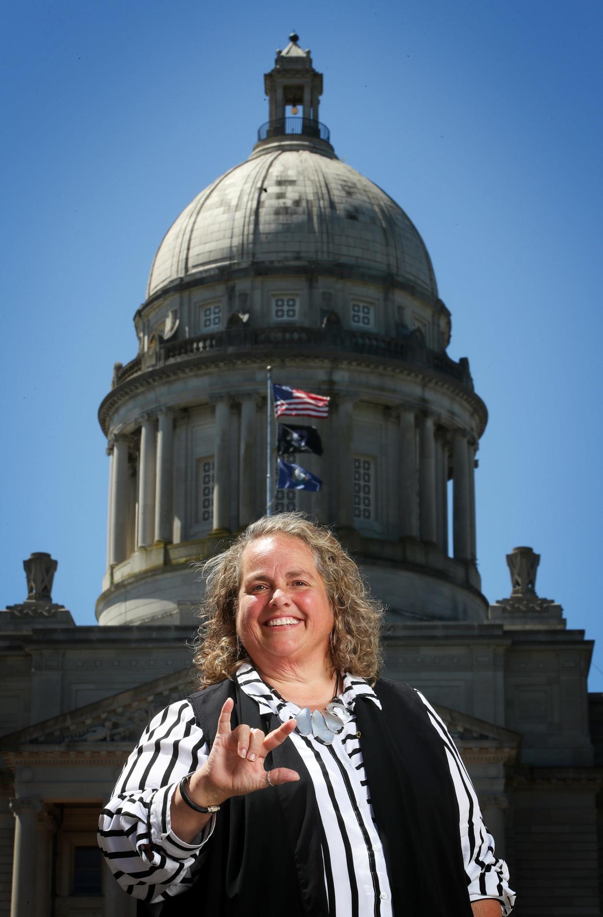 Virginia Moore, Executive Director of the Kentucky Commission on the Deaf and Hard of Hearing signs "I Love You".