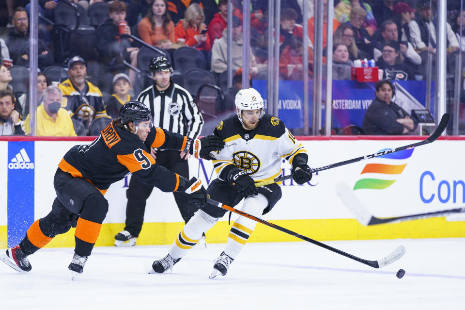 Boston Bruins' A.J. Greer, right, battles with Philadelphia Flyers' Ivan Provorov, left, for the puck during the first period of an NHL hockey game, Sunday, April 9, 2023, in Philadelphia. (AP Photo/Chris Szagola)