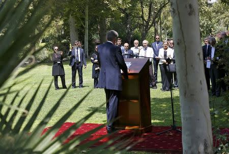 Embassy workers listen to Britain's Foreign Secretary Philip Hammond during the reopening of the British Embassy in Tehran, Iran August 23, 2015. REUTERS/Darren Staples