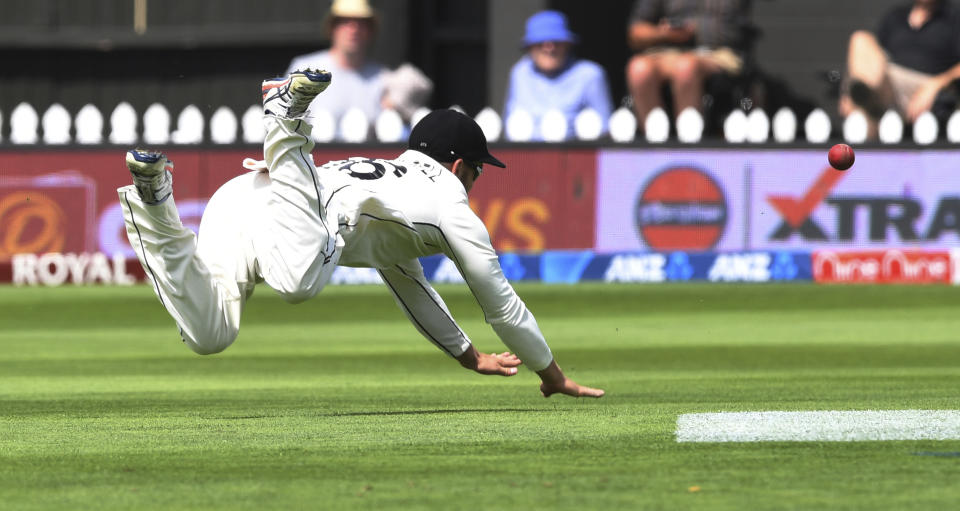 New Zealand's Tom Blundell dives after ball against India during the first cricket test between India and New Zealand at the Basin Reserve in Wellington, New Zealand, Saturday, Feb. 22, 2020. (AP Photo/Ross Setford)