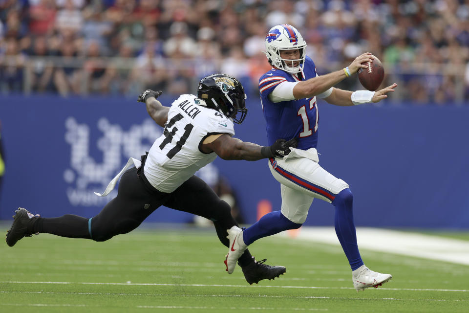 Buffalo Bills quarterback Josh Allen (17) is tackled by Jacksonville Jaguars linebacker Josh Allen (41) during an NFL football game between Jacksonville Jaguars and Buffalo Bills at the Tottenham Hotspur stadium in London, Sunday, Oct. 8, 2023. (AP Photo/Ian Walton)