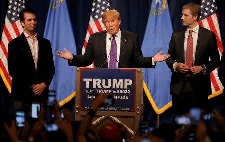 Donald Trump is flanked by his sons as he addresses supporters after being declared by the television networks as the winner of the Nevada Republican caucuses at his caucus night rally in Las Vegas. REUTERS/Jim Young