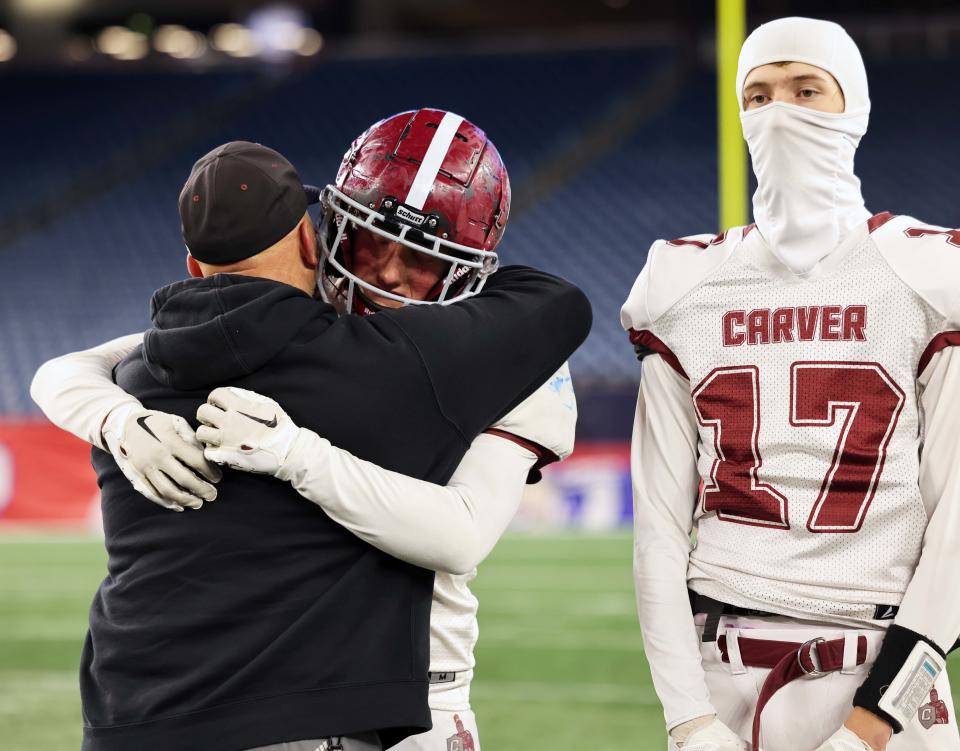 Carver head coach Ben Shuffain comforts Jameson Helms at the conclusion of the Division 8 state title game against West Boylston at Gillette Stadium on Wednesday, Nov. 29, 2023.