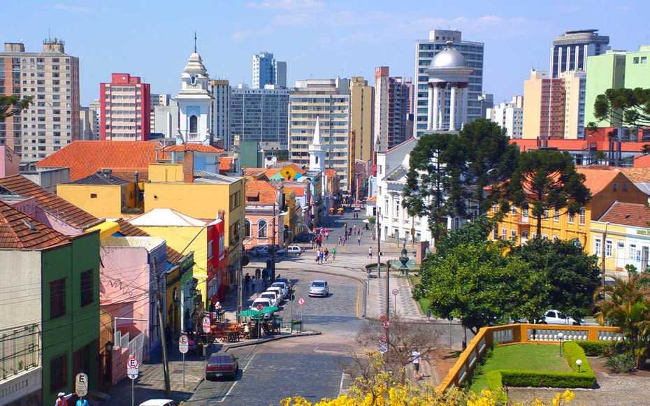 <p>If you’re ready for a change of pace from Rio, head south to Curitiba, the capital of the Brazilian state of Paraná and a shining example of urban planning in action. The city is a cultural hub thanks to the Wire Opera House, the Teatro Guaíra, and the visually stunning Oscar Niemeyer Museum.</p> <p>The easiest way to get around is via bicycle. Bike paths crisscross the city, connecting neighborhoods to one another, and the government is adding more paths all the time, making it one of Travel + Leisure’s <a rel="nofollow noopener" href="http://www.travelandleisure.com/slideshows/best-biking-cities-on-earth/16" target="_blank" data-ylk="slk:Best Biking Cities on Earth;elm:context_link;itc:0;sec:content-canvas" class="link ">Best Biking Cities on Earth</a>. If you’re more of a bus rider than a biker, 80% of the residents of Curitiba ride the city’s rail system, justifying its title as a <a rel="nofollow noopener" href="http://www.travelandleisure.com/slideshows/worlds-most-visionary-cities/10" target="_blank" data-ylk="slk:visionary city;elm:context_link;itc:0;sec:content-canvas" class="link ">visionary city</a> for public transportation.</p> <p>However you choose to travel, be sure to spend a day wandering the Botanical Gardens, a replica of a classic French garden with a modernist twist, filled with fountains, lakes, and an art nouveau greenhouse that glows at night. Head to the pedestrian-only cobblestone streets of the city’s remaining colonial center, Largo da Ordem, which is lined with beautifully restored buildings housing cafés and bars.</p>