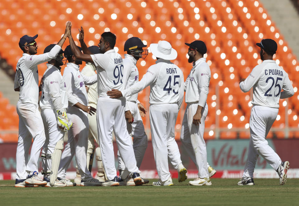 India's Ravichandran Ashwin, center without cap, celebrates with teammates the dismissal of England's Ollie Pope during the first day of fourth cricket test match between India and England at Narendra Modi Stadium in Ahmedabad, India, Thursday, March 4, 2021. (AP Photo/Aijaz Rahi)