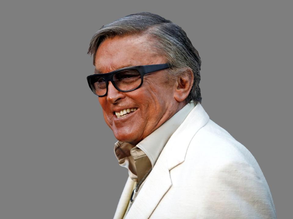 Robert Evans headshot, movie producer, graphic element on gray