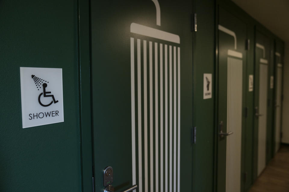 Shared showers are seen in the Starlight affordable housing building, which is run by Central City Concern, a Portland-based homeless services nonprofit, on Friday, March 15, 2024, in Portland, Ore. The nonprofit leases more than 1,000 single room occupancy units, both subsidized and not, to people who are considered extremely low-income. It helps people struggling to access housing due to things like eviction histories and poor credit scores. (AP Photo/Jenny Kane)