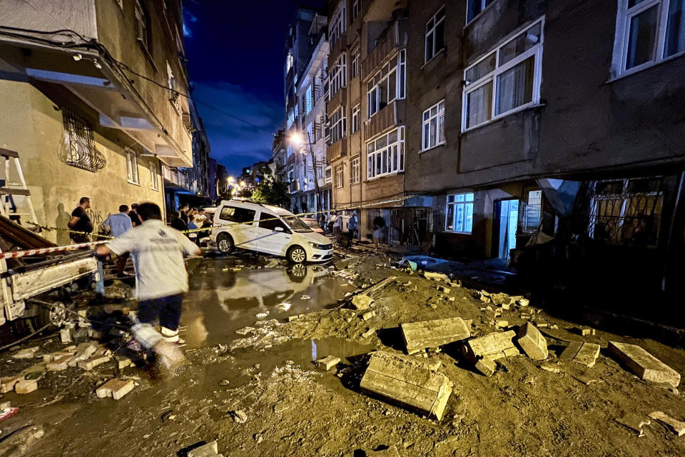 Vehicles and debris are scattered on a street in Istanbul on Wednesday after heavy flooding. 