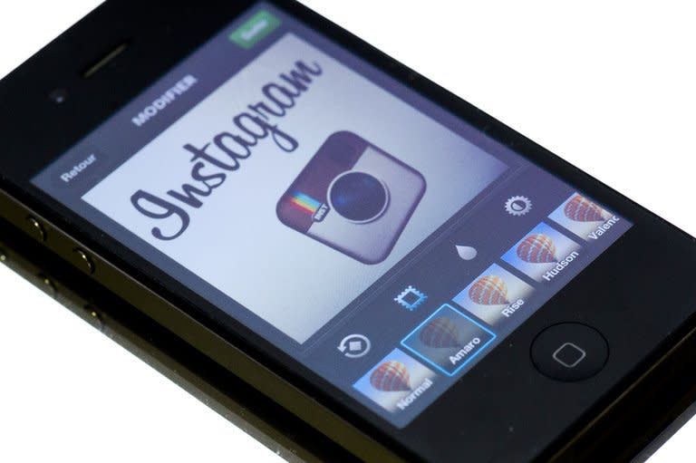 The Instagram logo is displayed on a smartphone on December 20, 2012 in Paris. Instagram tried to calm a user rebellion by nixing a change that would have given the Facebook-owned mobile photo sharing service unfettered rights to people's pictures