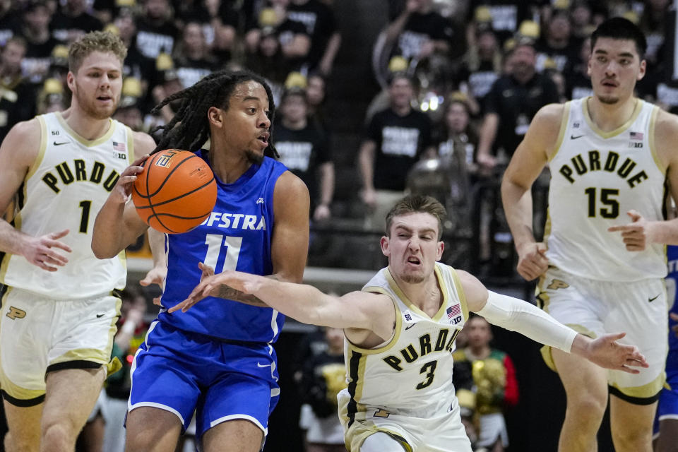 Purdue guard Braden Smith (3) comes form behind Hofstra guard Jaquan Carlos (11) to knock the ball loose during the first half of an NCAA college basketball game in West Lafayette, Ind., Wednesday, Dec. 7, 2022. (AP Photo/Michael Conroy)