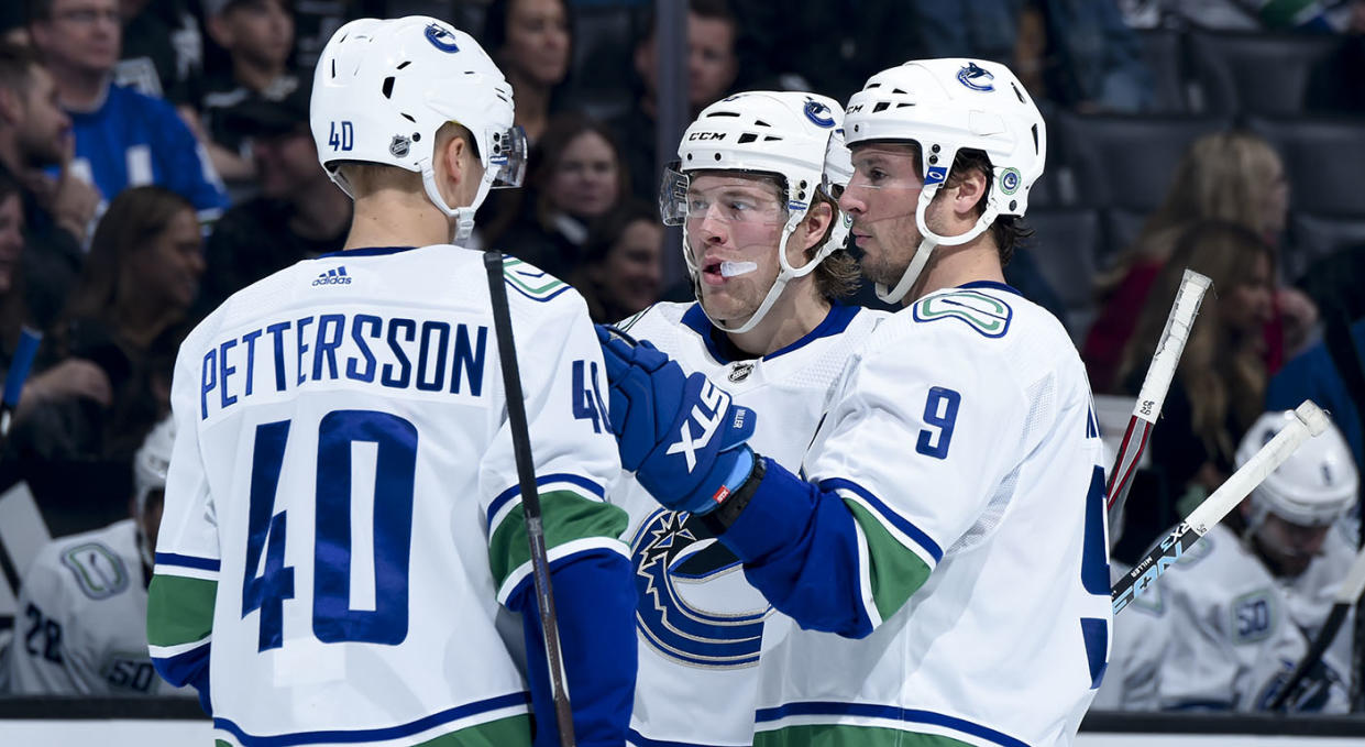 LOS ANGELES, CA - OCTOBER 30: Elias Pettersson #40, Brock Boeser #6, and J.T. Miller #9 of the Vancouver Canucks talk while waiting for play to resume during the second period of the game against the Los Angeles Kings at Staples Center on October 30, 2019 in Los Angeles, California. (Photo by Juan Ocampo/NHLI via Getty Images)