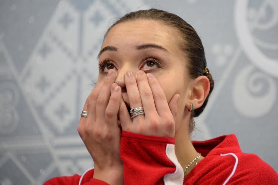 Russia's Adelina Sotnikova reacts in the kiss and cry zone during the Women's Figure Skating Free Program at the Iceberg Skating Palace during the Sochi Winter Olympics on February 20, 2014. AFP PHOTO / DAMIEN MEYER        (Photo credit should read DAMIEN MEYER/AFP/Getty Images)