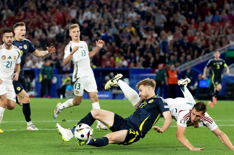 Penalty Claim for Scotland as Stuart Armstrong goes down in the box under a challenge from Willi Orban