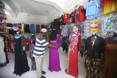 A worker dresses a shop mannequin at a supermarket in Mogadishu October 2, 2013. REUTERS/Feisal Omar