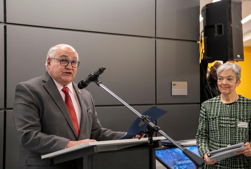 Framingham Mayor Charlie Sisitsky reads a proclamation during the grand reopening of the Christa McAuliffe Center for Integrated Science Learning at Framingham State University, Jan. 26, 2024. At right is Dr. Irene Porro, direc­tor of the center.