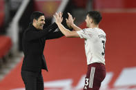 Arsenal's manager Mikel Arteta, left, celebrates with Arsenal's Kieran Tierney end of the English Premier League soccer match between Manchester United and Arsenal at the Old Trafford stadium in Manchester, England, Sunday, Nov. 1, 2020. (Paul Ellis/Pool via AP)