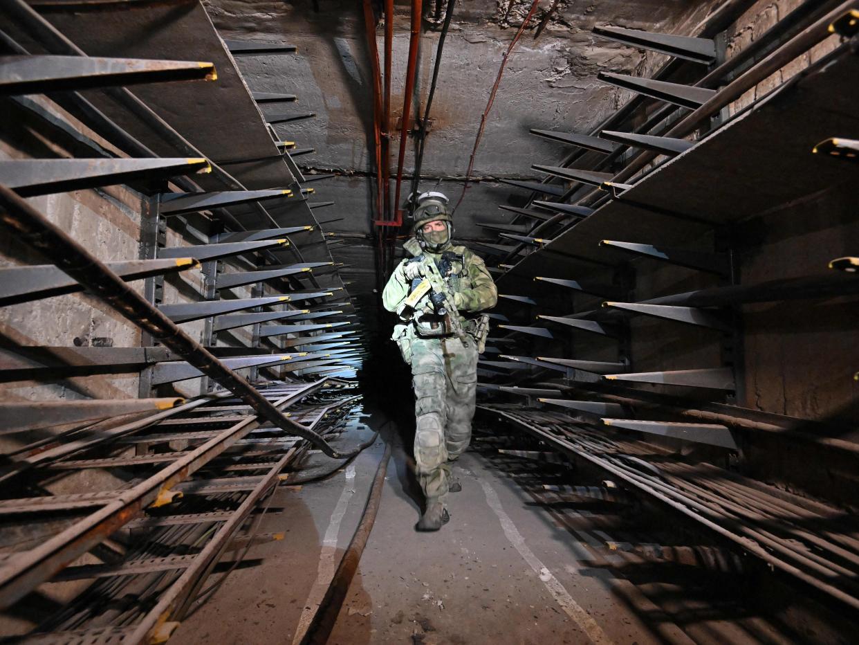 A Russian serviceman inspects an underground tunnel under the Azovstal steel plant in Mariupol, June 13, 2022