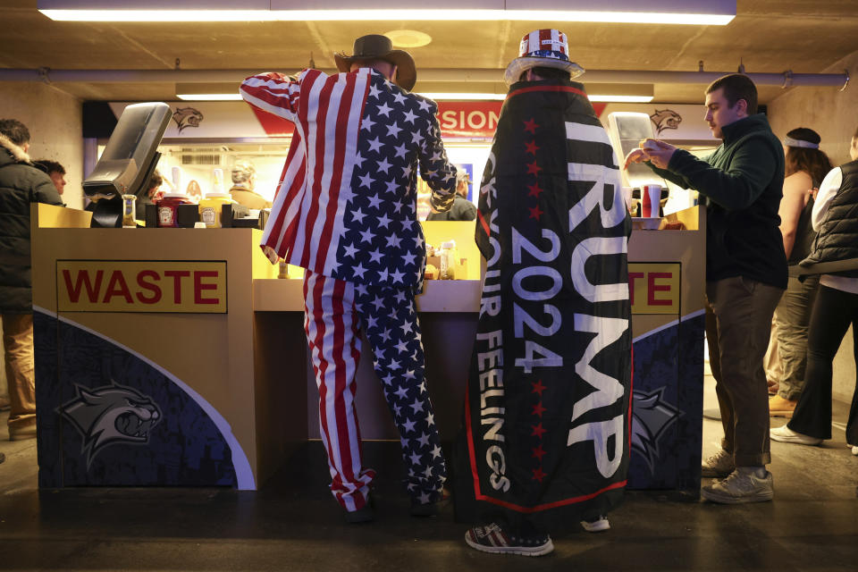 An attendee buy food during a campaign rally for Former president Donald Trump Saturday Dec. 16, 2023, in Durham, N.H. (AP Photo/Reba Saldanha)