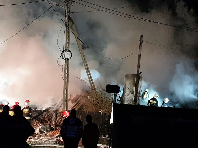 Firefighters work at site of building levelled by gas explosion in Szczyrk