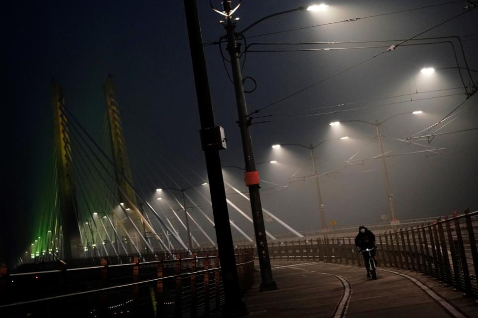 Street lamps on the Tilikum Crossing Bridge illuminate smoke from wildfires Sept. 13, 2020, in Portland, Ore.  