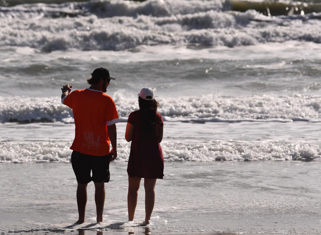 Matthew and Keelyn Spruce, on vacation from Arizona, check out the rough surf in Cocoa Beach. With the strong winds, not a great day at the beach. Rip current warnings are out along the coast.