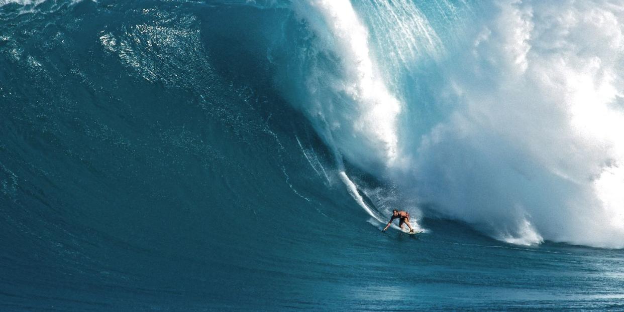 a person surfing a large wave