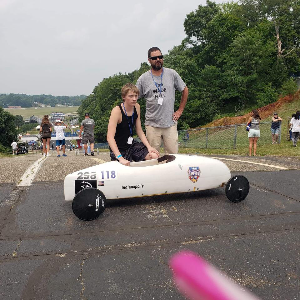 Caiden Clements, 17, and his car handler Wade Hill at a Soap Box Derby competition.
