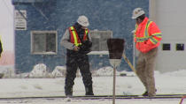 Rail workers investigate a section of track after three contractors were hit while clearing snow east of Edmonton on Boxing Day. 