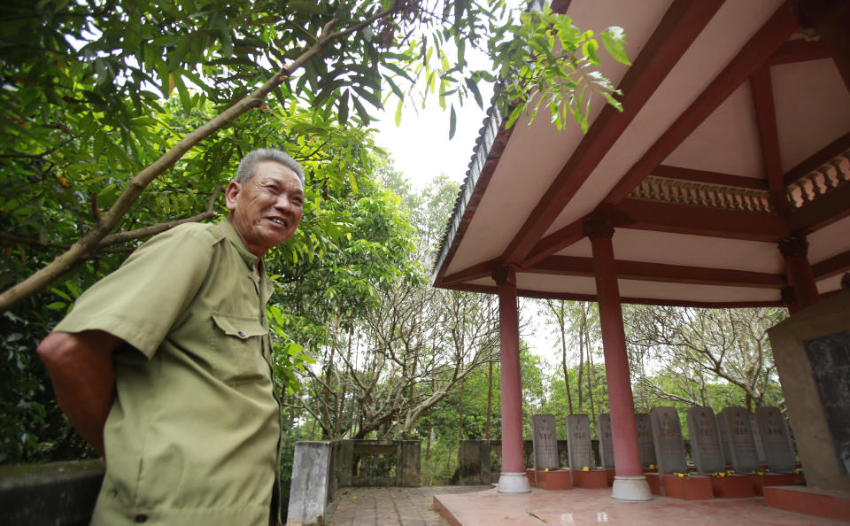 In this Feb. 16, 2019, photo, veteran Duong Van Dau smiles while standing at a memorial for North Korean fallen pilots in Bac Giang province, Vietnam. The fourteen headstones of the pilots who died while fighting American bombers alongside the Vietnamese army during the Vietnam war remain as a symbol of Vietnam-North Korea friendship. (AP Photo/Hau Dinh)