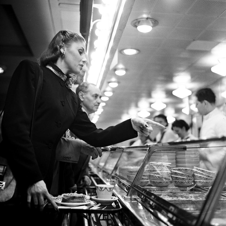 <p>A female diner in Grand Central Station makes her way through the hot food line. </p>