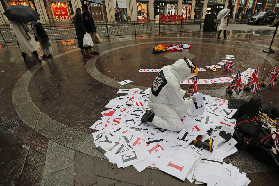 <p>An artist puts letters together as an installation in a virtually empty square during the Covid-19 lockdown in London, Tuesday, Feb. 16, 2021.(AP Photo/Frank Augstein)</p>
