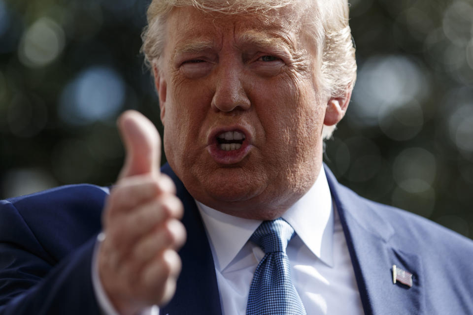 FILE - In this Oct. 4, 2019, file photo, President Donald Trump talks to reporters on the South Lawn of the White House, in Washington. The nation's business economists think President Trump's trade war with China will contribute to a sharp slowdown in economic growth this year and next, raising concerns about a possible recession starting late next year. (AP Photo/Evan Vucci, File)