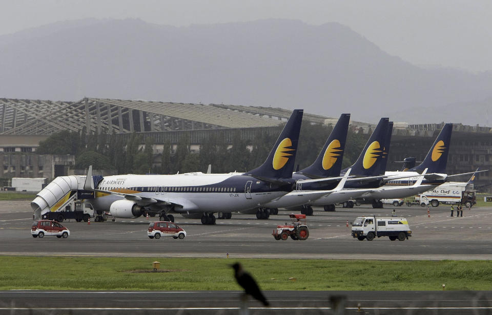 FILE - In this Sept. 9, 2009 file photo, Jet Airways planes are parked on the tarmac at the domestic airport terminal in Mumbai, India. In recent months, Abu Dhabi’s Etihad Air announced it was taking a $379 million stake in India’s Jet Airways. India has become a hot ticket for international carriers since opening its airline industry to foreign investors last year. But the potential of a giant market where only a sliver of the population travel by plane also comes with a catch: airlines in India are vastly unprofitable thanks to sky-high costs and cut-throat competition. (AP Photo/Rajanish Kakade, file)