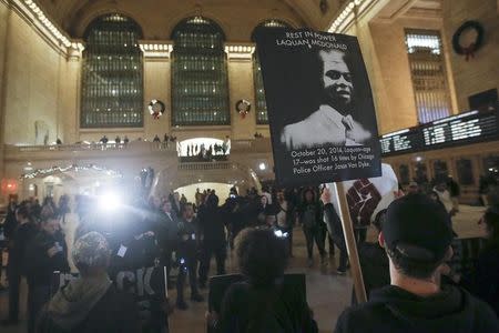 Black Lives Matter protesters chant slogans in Grand Central Terminal as they protest the 2014 death of Laquan McDonald from Chicago in the Manhattan borough of New York December 14, 2015. REUTERS/Carlo Allegri