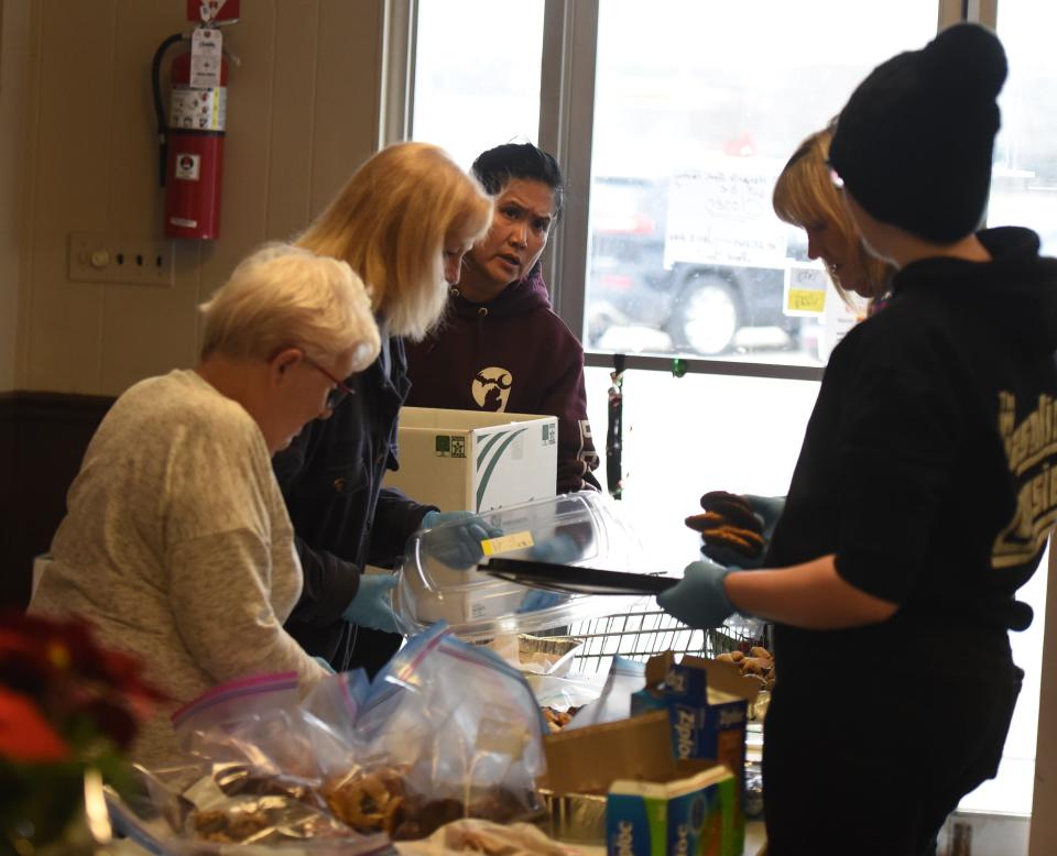 Volunteers with the SOS Marysville Food Pantry prepare meals they will deliver Christmas morning. From left to right: Lavonne Cloutier, Dana Westphal, Carmela Burns, Rose Westbrook and Shiann Gilbert.