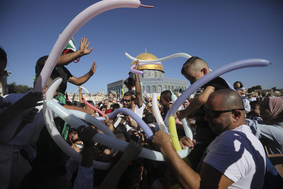 Palestinains celebrate the Islamic holiday of Eid al-Adha.in front of the Dome of then Rock shrine in Jerusalem, Sunday, Aug 11, 2019. (AP Photo/Mahmoud Illean)