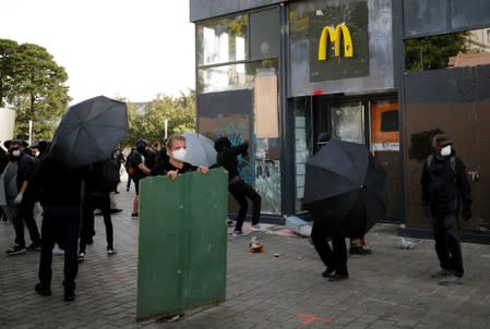 Masked protesters vandalize a McDonald's restaurant during a demonstration on Act 44 (the 44th consecutive national protest on Saturday) of the yellow vests movement in Nantes