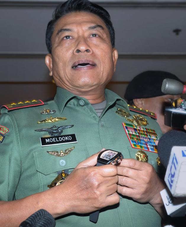 Indonesian military chief General Moeldoko displays his luxury watch to journalists in Jakarta which he claims is a fake, April 23, 2014