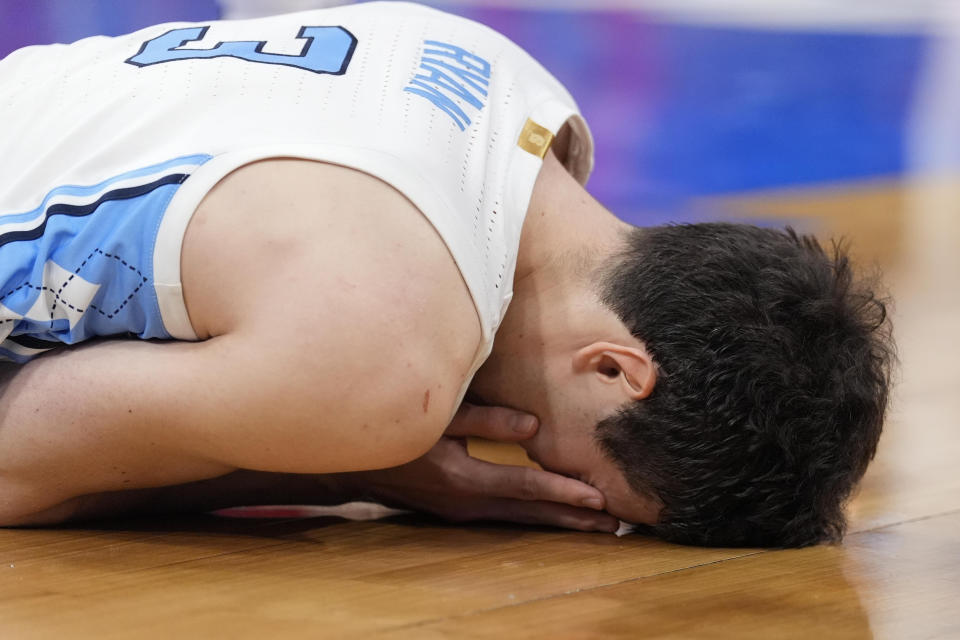 North Carolina guard Cormac Ryan (3) lays on the court after getting banged up in a play against North Carolina State during the second half of an NCAA college basketball game in the championship of the Atlantic Coast Conference tournament, Saturday, March 16, 2024, in Washington. (AP Photo/Alex Brandon)